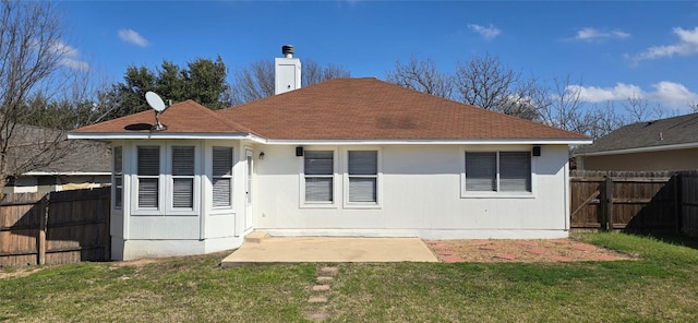 rear view of property featuring a yard and a patio area