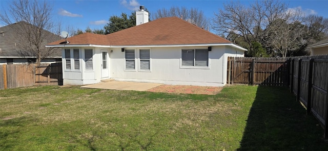 rear view of house with a patio and a yard