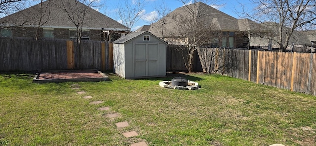 view of yard featuring a storage shed and a fire pit