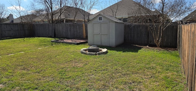 view of yard with a fire pit and a shed