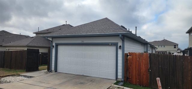 exterior space with concrete driveway and fence