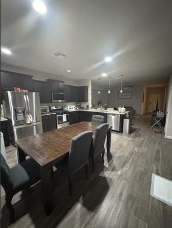 dining space with visible vents and wood finished floors