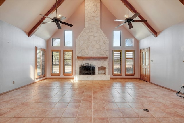 unfurnished living room with light tile patterned floors, plenty of natural light, a fireplace, and ceiling fan