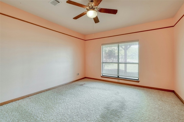 carpeted spare room with ceiling fan