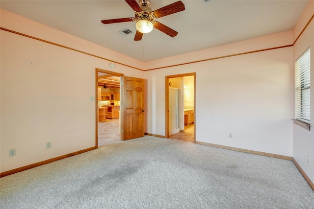 spare room featuring light colored carpet and ceiling fan