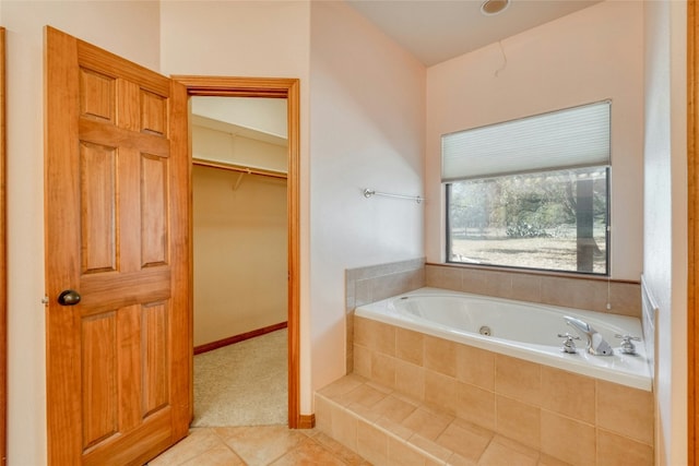 bathroom featuring tile patterned flooring and tiled tub