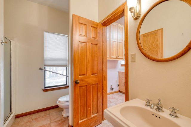 bathroom with tile patterned flooring, toilet, an enclosed shower, and sink