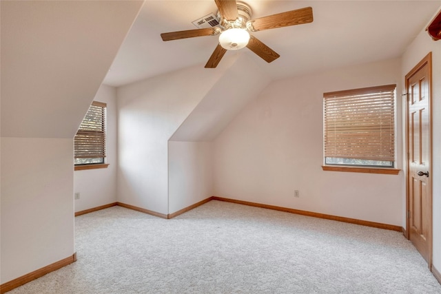 additional living space with lofted ceiling, light colored carpet, and ceiling fan