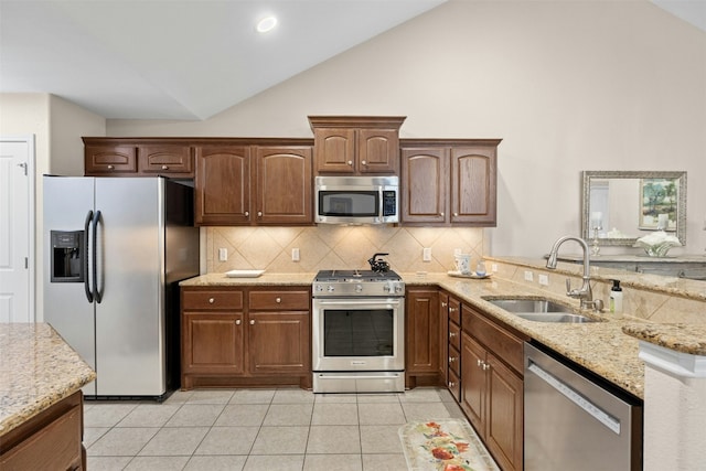 30 Wildwood Dr Unit 41, Georgetown, TX 78633 - kitchen featuring appliances with stainless steel finishes, a sink, light stone counters, tasteful backsplash, and high vaulted ceiling