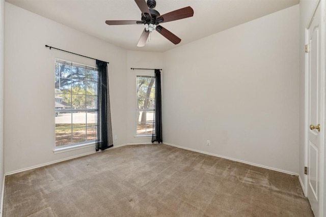 spare room with a healthy amount of sunlight and light carpet