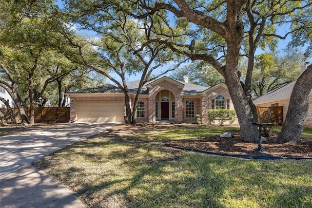 ranch-style house featuring a garage and a front yard