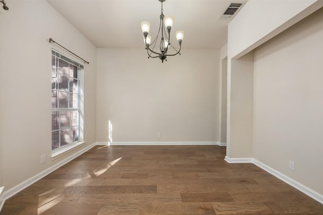 unfurnished dining area featuring a notable chandelier and dark hardwood / wood-style flooring