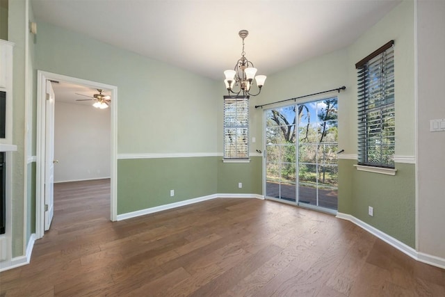 unfurnished room with ceiling fan with notable chandelier and wood-type flooring