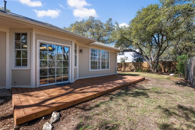 exterior space featuring a wooden deck and a lawn