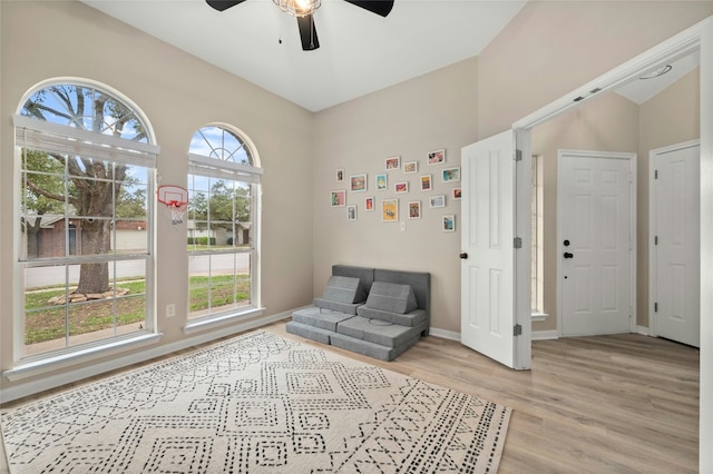 sitting room with light hardwood / wood-style flooring and ceiling fan