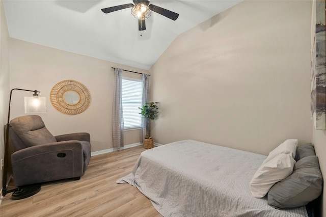 bedroom featuring ceiling fan, vaulted ceiling, and light wood-type flooring