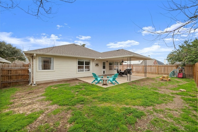 back of property with a patio and a yard