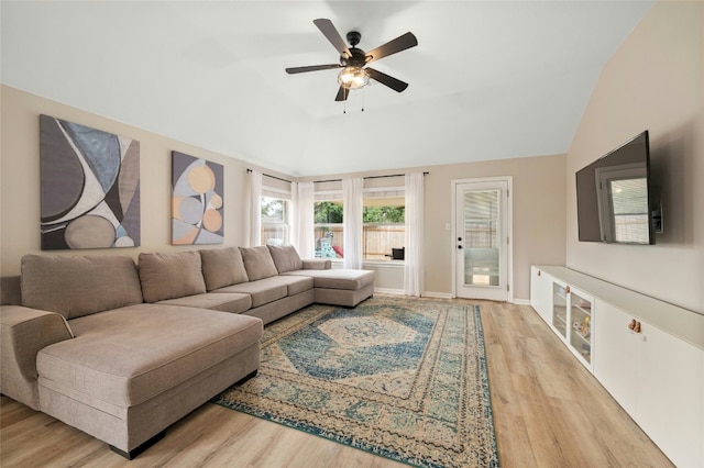 living room featuring ceiling fan, vaulted ceiling, and light hardwood / wood-style flooring