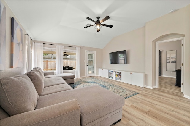 living room featuring ceiling fan, vaulted ceiling, and light hardwood / wood-style flooring