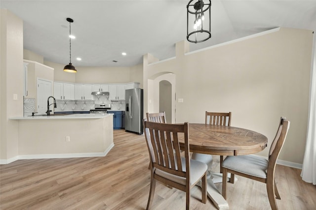 dining space featuring sink and light wood-type flooring