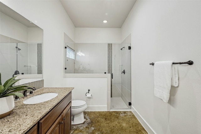 bathroom with toilet, a stall shower, baseboards, and vanity