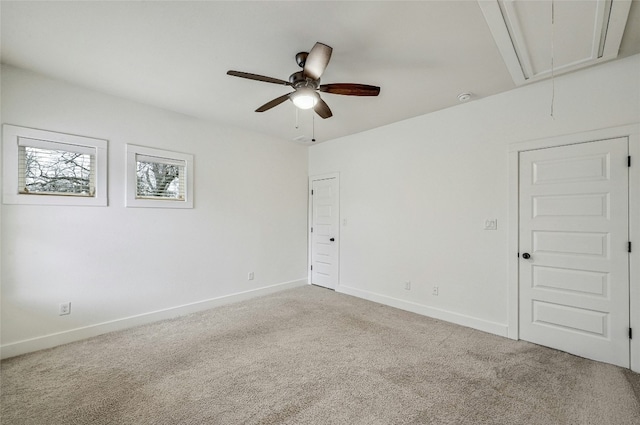 carpeted spare room featuring ceiling fan