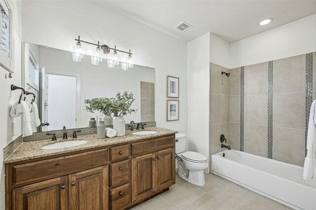 full bathroom featuring tile patterned flooring, vanity, toilet, and tiled shower / bath