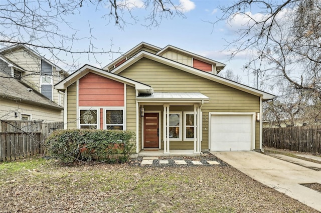 view of front facade featuring driveway, an attached garage, and fence