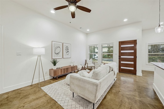 living room with concrete floors and ceiling fan