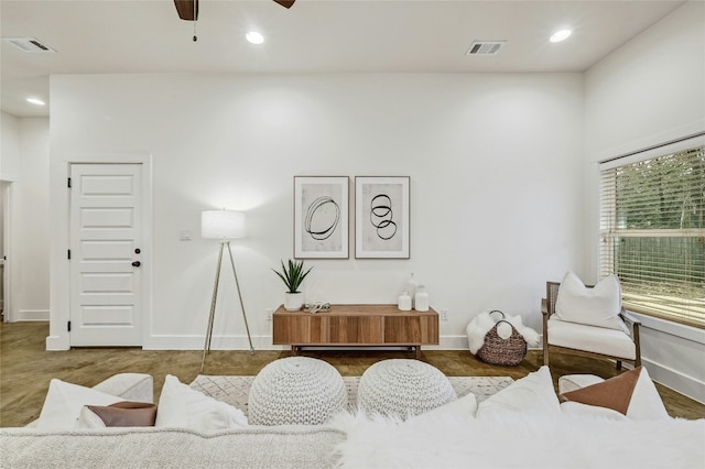 living area with ceiling fan, visible vents, and recessed lighting