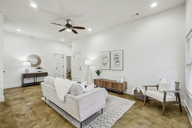 living room featuring concrete floors and ceiling fan