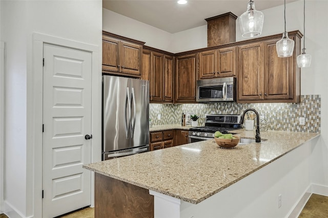 kitchen featuring decorative light fixtures, decorative backsplash, kitchen peninsula, stainless steel appliances, and light stone countertops