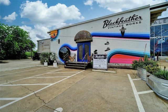 view of building exterior featuring uncovered parking