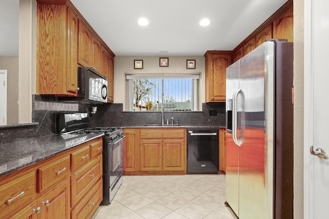 kitchen featuring light tile patterned flooring, sink, dark stone countertops, decorative backsplash, and black appliances