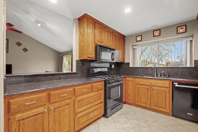 kitchen with sink, light tile patterned floors, backsplash, black appliances, and vaulted ceiling