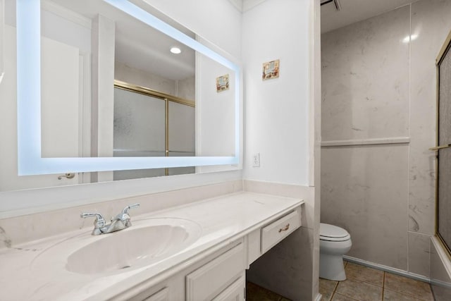 full bathroom featuring vanity, toilet, tile patterned flooring, and combined bath / shower with glass door