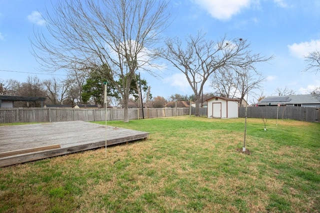 view of yard with a storage shed and a deck