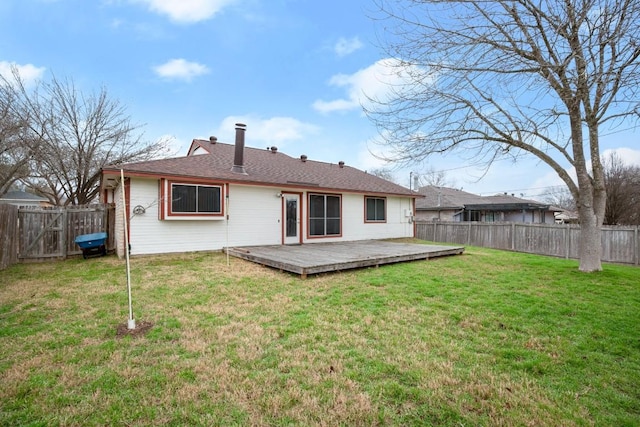 back of house with a wooden deck and a yard