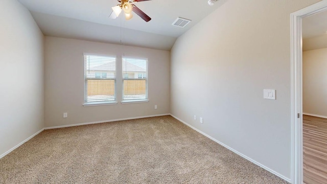 unfurnished room with lofted ceiling, light colored carpet, and ceiling fan