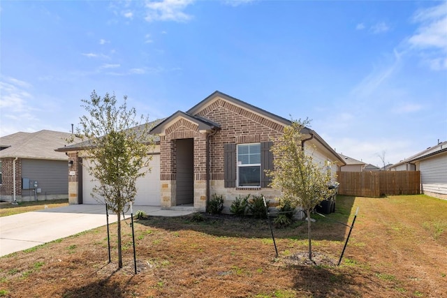 view of front of house with a front yard, fence, driveway, a garage, and brick siding