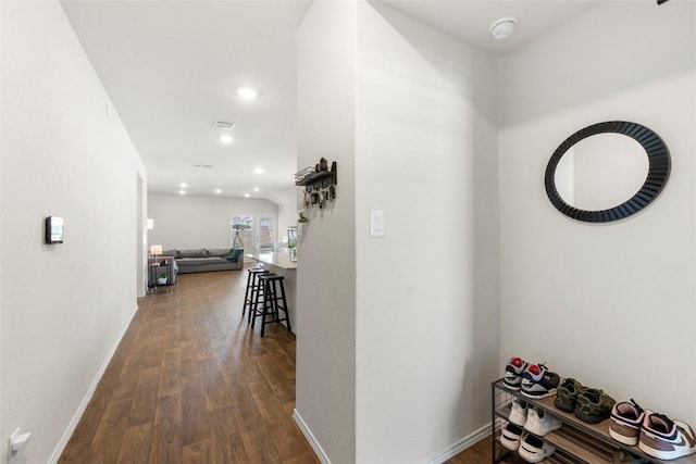 hallway featuring visible vents, recessed lighting, dark wood-style floors, and baseboards