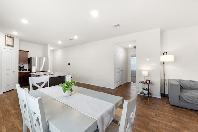 dining room with visible vents, recessed lighting, dark wood-type flooring, and baseboards