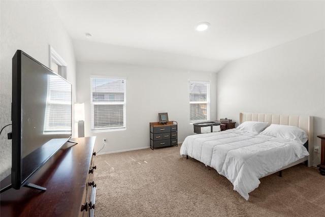 bedroom with multiple windows, lofted ceiling, carpet, and baseboards