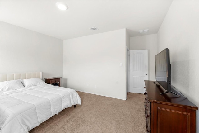 bedroom featuring visible vents, light colored carpet, and baseboards