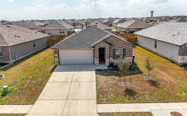 view of front of property featuring a front yard, driveway, an attached garage, a shingled roof, and a residential view