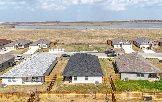 drone / aerial view featuring a water view and a residential view