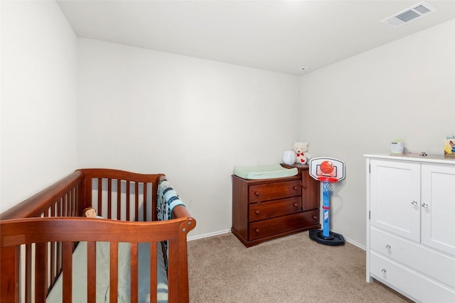 bedroom with light carpet, visible vents, and baseboards