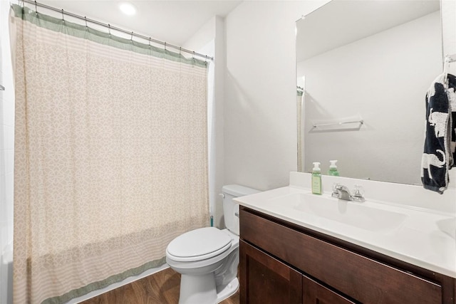 bathroom featuring toilet, wood finished floors, vanity, and shower / bath combination with curtain