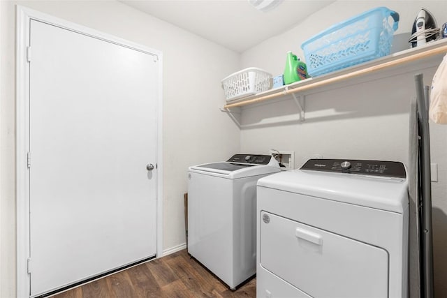 clothes washing area featuring laundry area, dark wood-style floors, and washing machine and clothes dryer