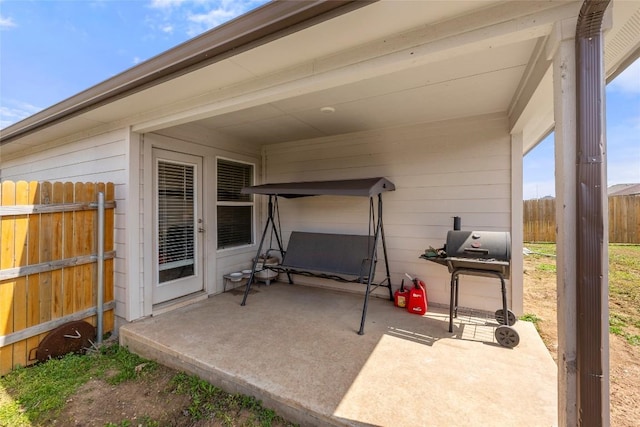 view of patio / terrace with area for grilling and fence